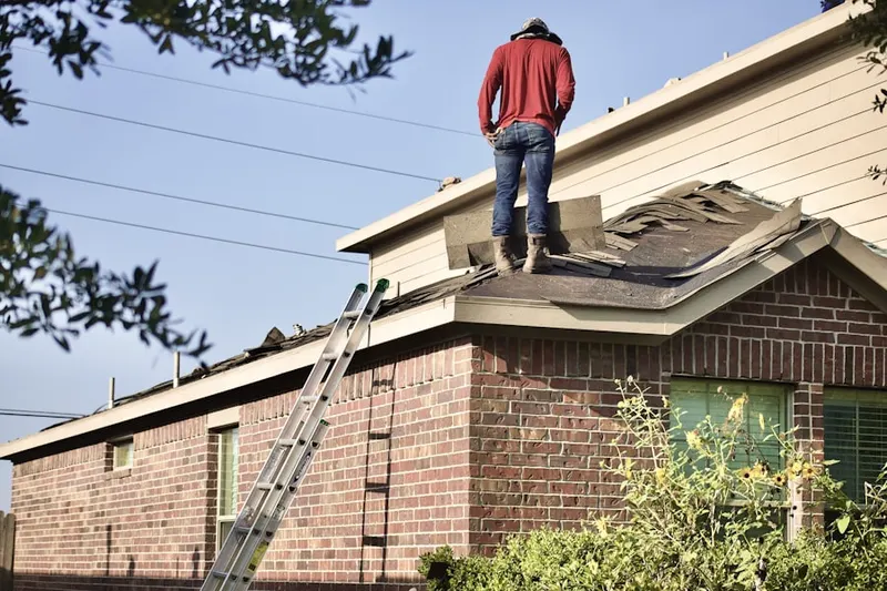 Professional roofer working on a residential roof in Eldorado at Santa Fe